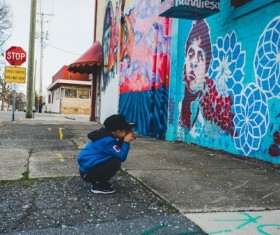 Little boy and colored painted wall Stock Photo