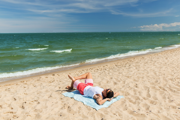 Man lying on the beach Stock Photo