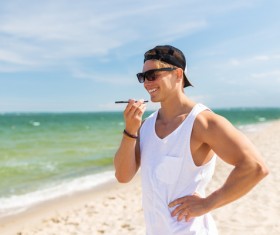 Man talking on the phone at the beach Stock Photo