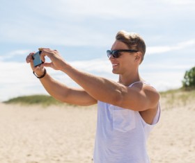 Man with smart phone self-timer Stock Photo 01