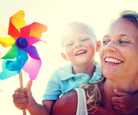 Mother carrying a small windmill with a child Stock Photo
