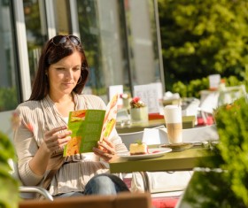 Outdoor cafe reading the menu of woman Stock Photo
