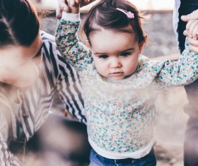 Parents take care of the little girl walking Stock Photo