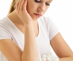 Sick girl with medicine on the table Stock Photo 01