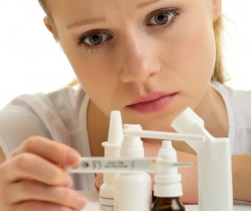 Sick girl with medicine on the table Stock Photo 02