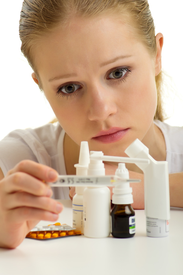 Sick girl with medicine on the table Stock Photo 02