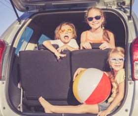 Sitting in the car trunk in children Stock Photo