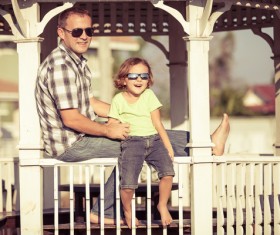 Sitting in the pavilion to rest the father and little girl Stock Photo