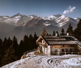 Small cottage on cold snow mountain Stock Photo