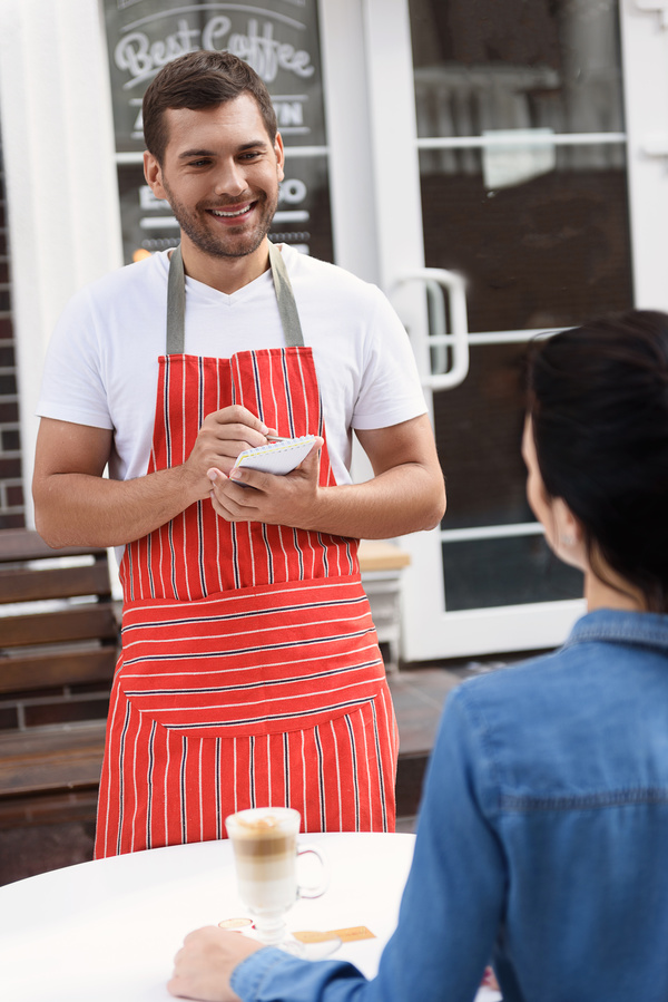 Smile coffee shop waiter for customer service Stock Photo