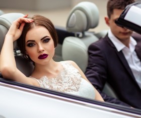 Stock Photo The bride and groom sitting in the wedding car 02