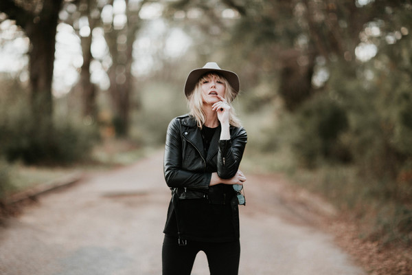 Stylish woman posing with leather coat Stock Photo