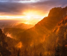 Sun beam on beautiful forest mountain scene Stock Photo