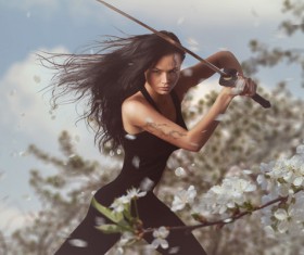 Sword wielding girls and white cherry blossoms Stock Photo