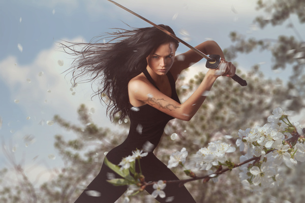 Sword wielding girls and white cherry blossoms Stock Photo