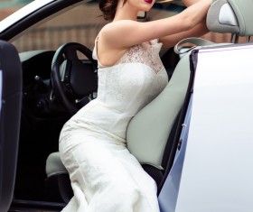 The beautiful bride sitting in a wedding car Stock Photo 02