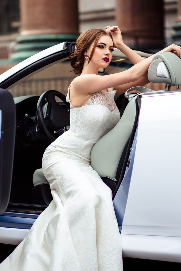 The beautiful bride sitting in a wedding car Stock Photo 02