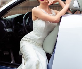 The beautiful bride sitting in a wedding car Stock Photo 04