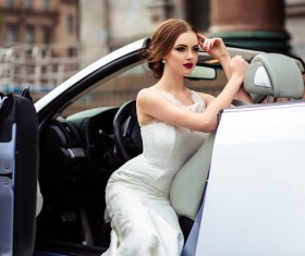 The beautiful bride sitting in a wedding car Stock Photo 05
