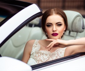 The beautiful bride sitting in a wedding car Stock Photo 07
