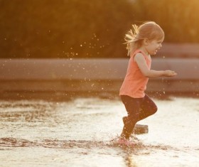 The little girl running in the water Stock Photo