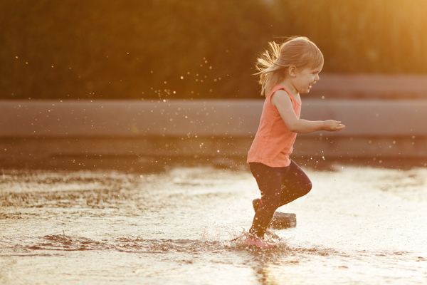 The little girl running in the water Stock Photo