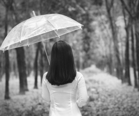 The woman with an umbrella back shadow Stock Photo