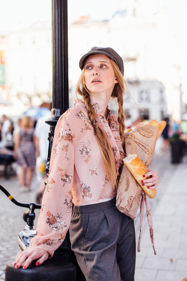 The young girl holding the bread on the street Stock Photo 02