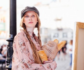 The young girl holding the bread on the street Stock Photo 03