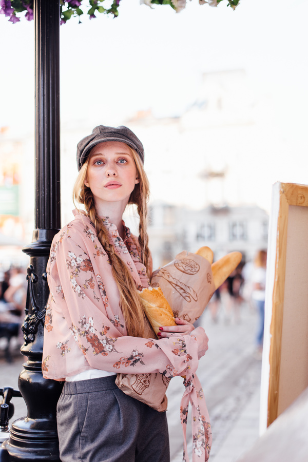 The young girl holding the bread on the street Stock Photo 03
