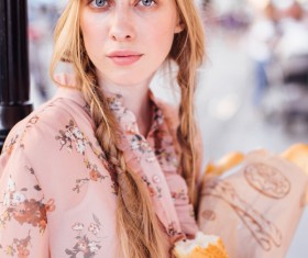 The young girl holding the bread on the street Stock Photo 04