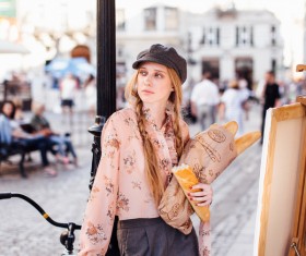The young girl holding the bread on the street Stock Photo 05