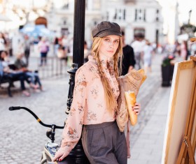 The young girl holding the bread on the street Stock Photo 06