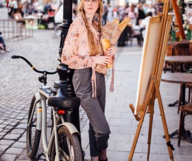 The young girl holding the bread on the street Stock Photo 07