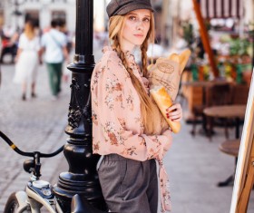 The young girl holding the bread on the street Stock Photo 08