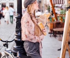 The young girl holding the bread on the street Stock Photo 09