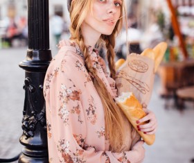 The young girl holding the bread on the street Stock Photo 10