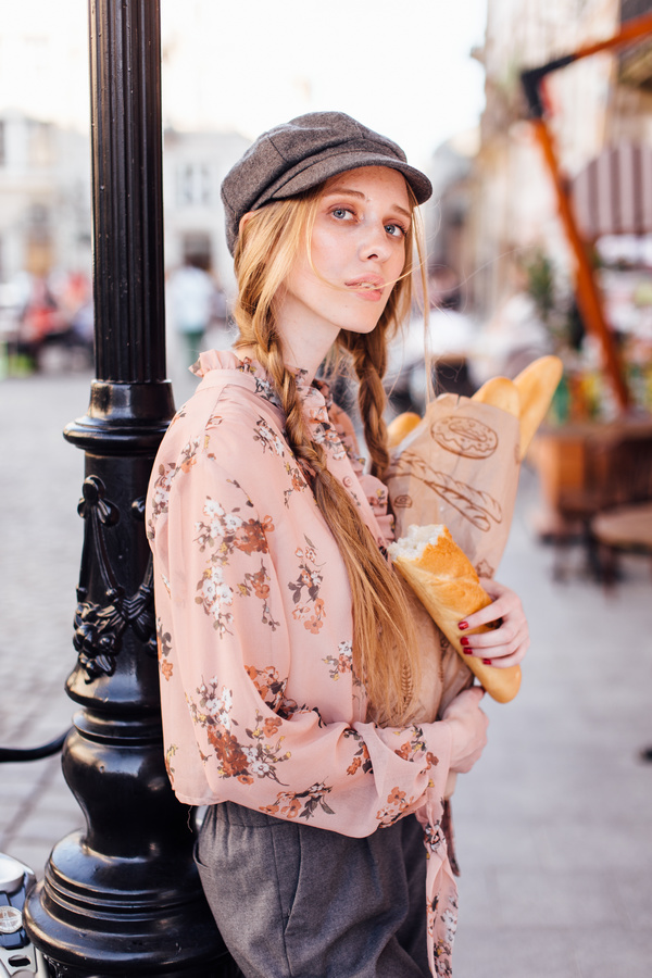 The young girl holding the bread on the street Stock Photo 10