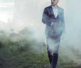 Walking handsome man in thick fog Stock Photo 01
