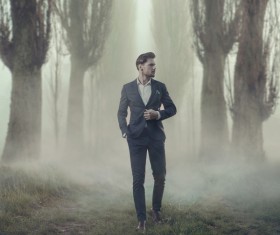 Walking handsome man in thick fog Stock Photo 02