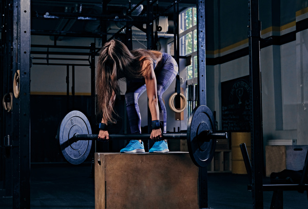 Woman in the gym lifting barbell Stock Photo 05