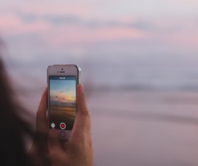 Woman taking camera with modern smartphone Stock Photo