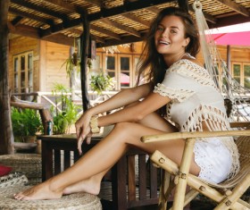 Young girl sitting on a bamboo chair resting Stock Photo 03