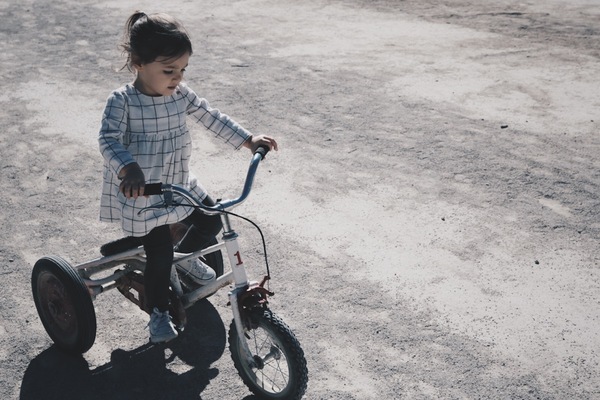 little girl practising riding bicycle Stock Photo