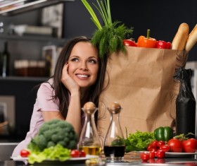 young woman who cooks in the kitchen Stock Photo 01