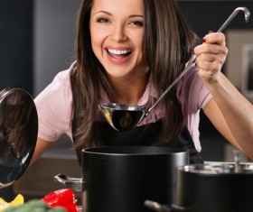 young woman who cooks in the kitchen Stock Photo 05