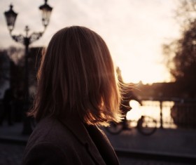 Blonde woman on road at dusk Stock Photo