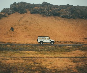 Car driving on empty mountain countryside Stock Photo