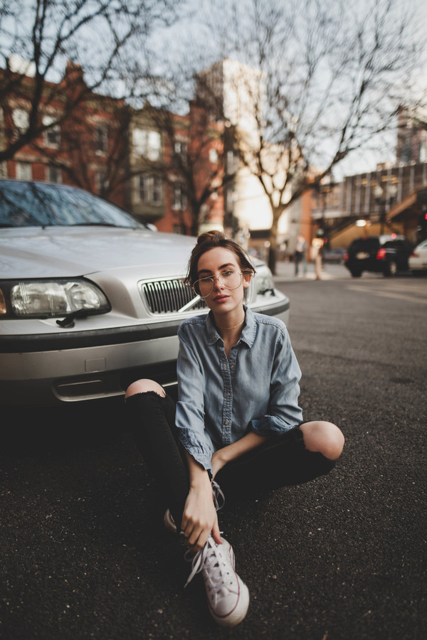 Cute young girl posing with car on street Stock Photo