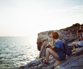 Friends taking photograph on calm beach Stock Photo